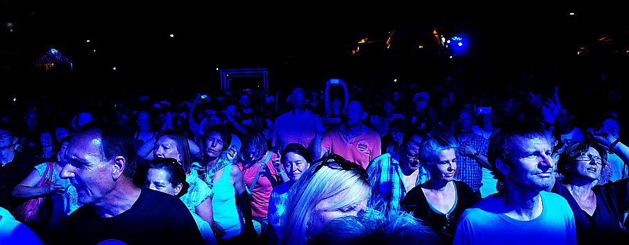 Audience at concert of Genesis connected